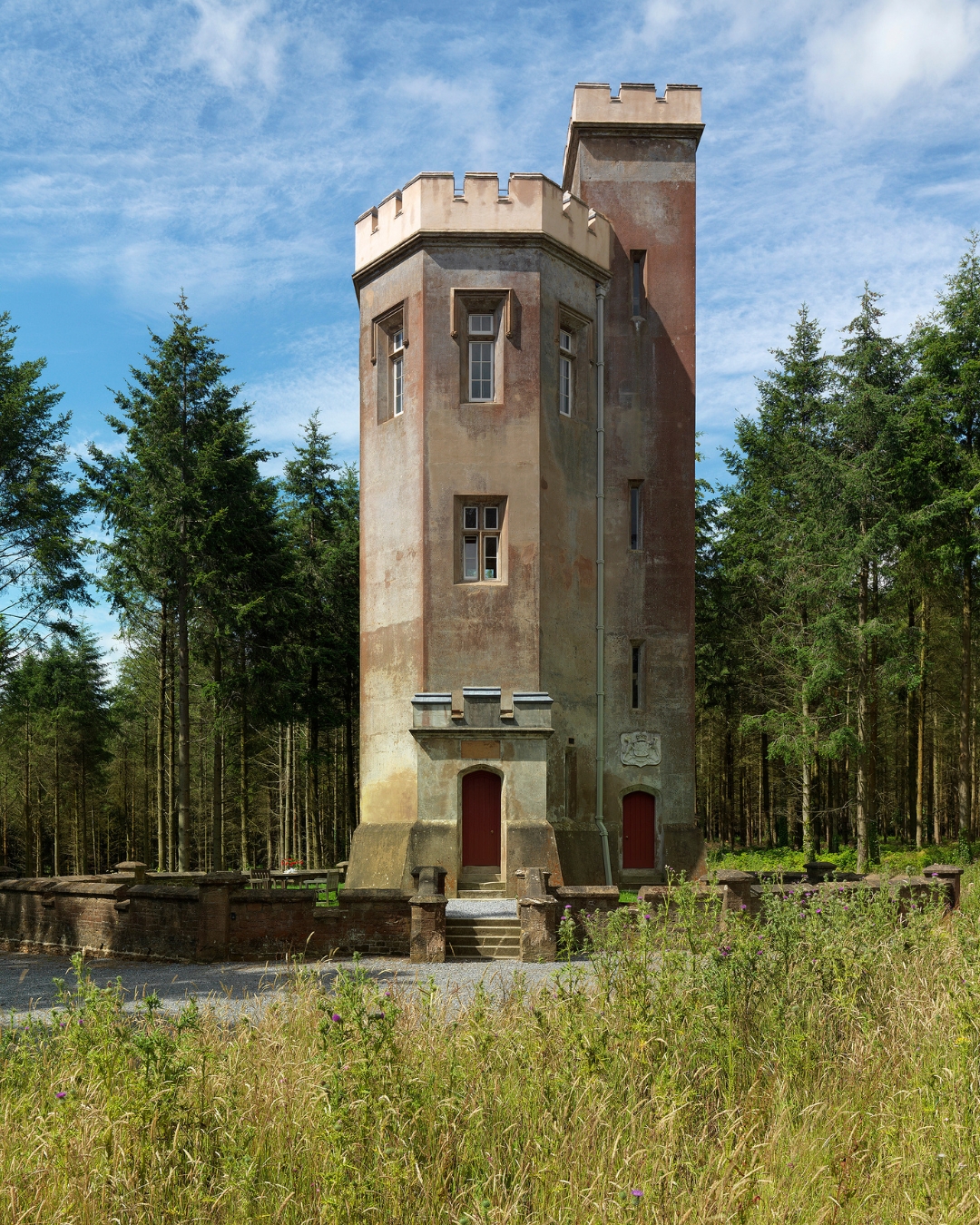 A Georgian folly standing in woodlands and fields
