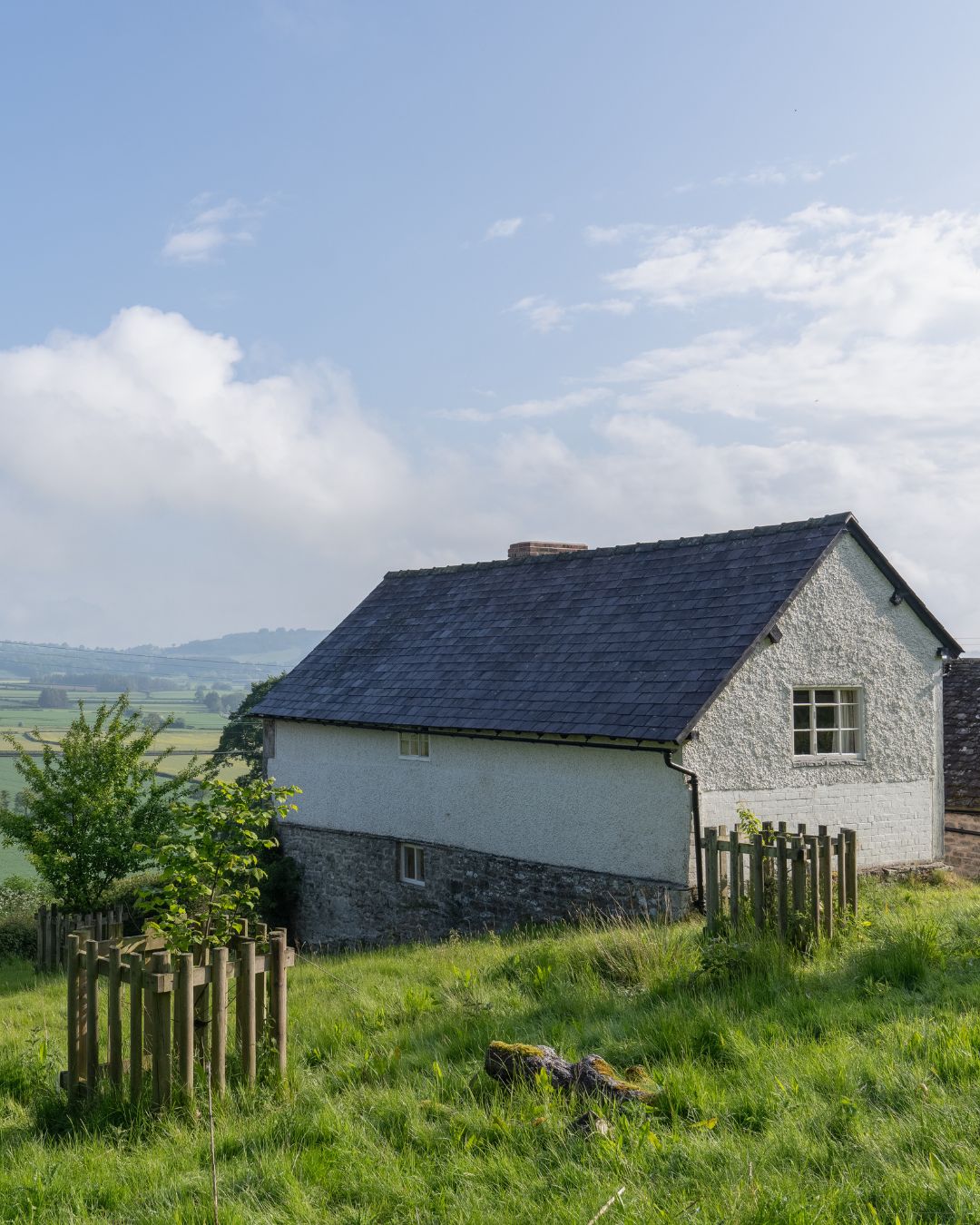 A farmhouse overlooking a lush green valley