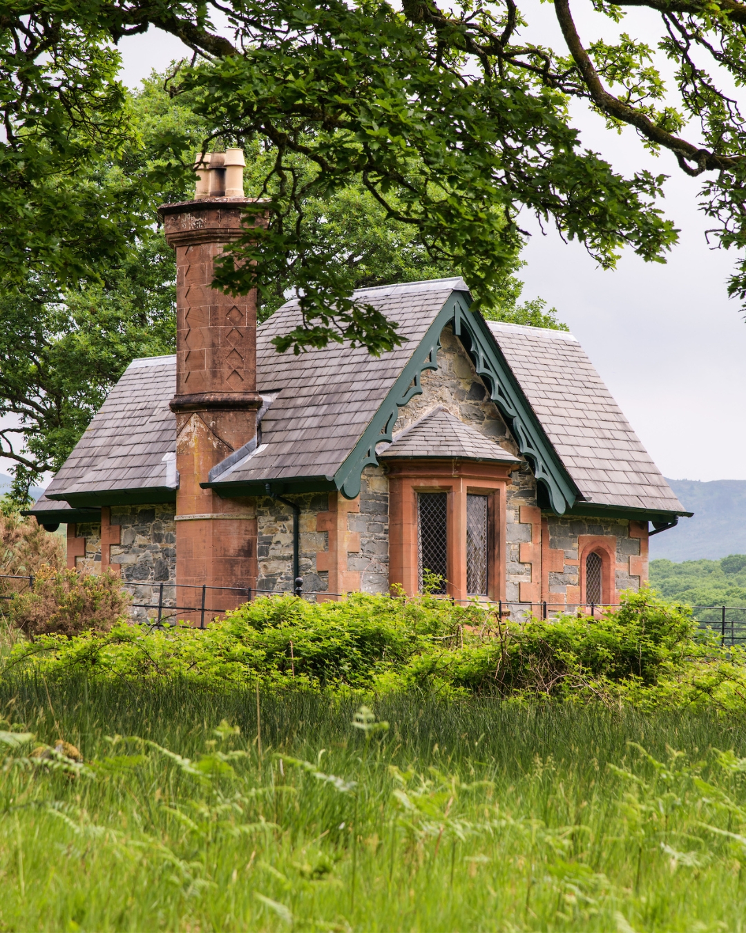 A small Victorian lodge surrounded by trees